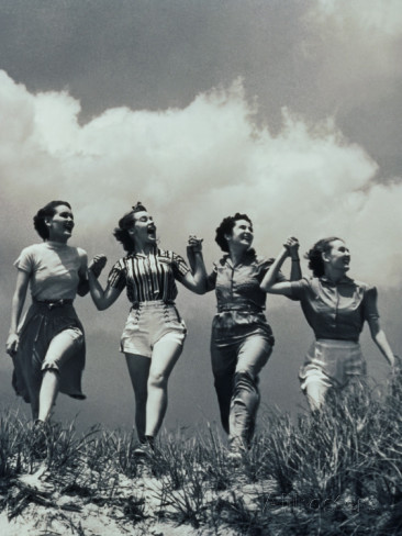 four-women-walking-in-a-line-holding-hands